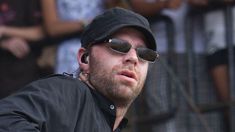 Michael Todd of Coheed and Cambria in sunglasses on stage
