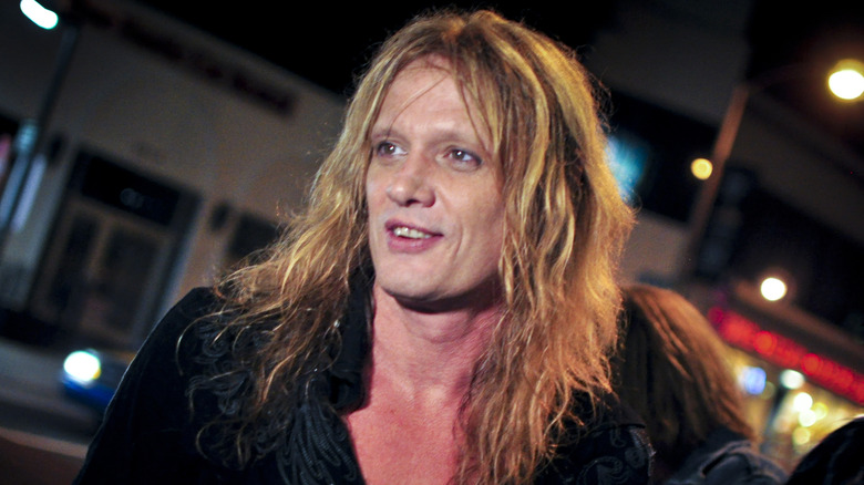 Sebastian Bach smiling on street