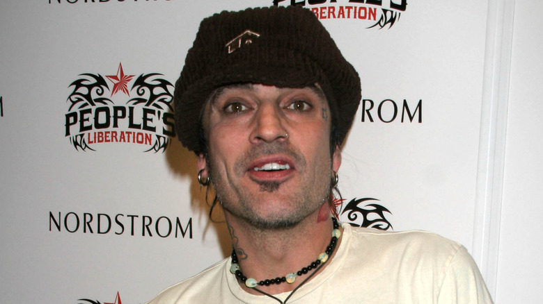 Tommy Lee wearing hat and necklace