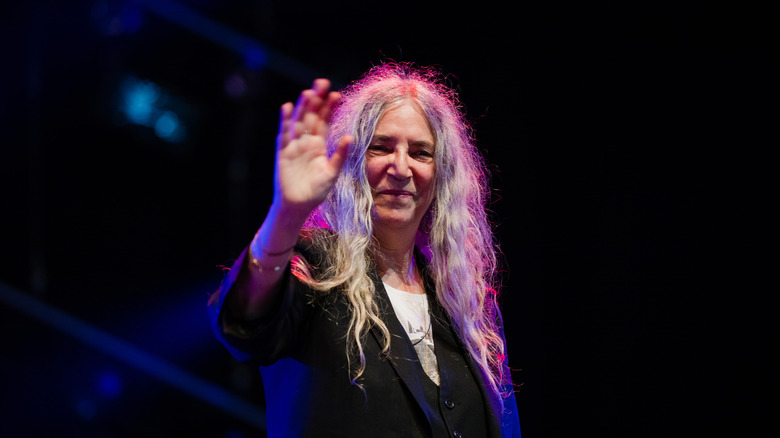 Patti Smith onstage waving