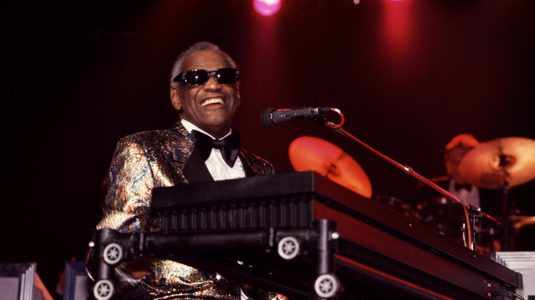 Ray Charles smiling at microphone and piano