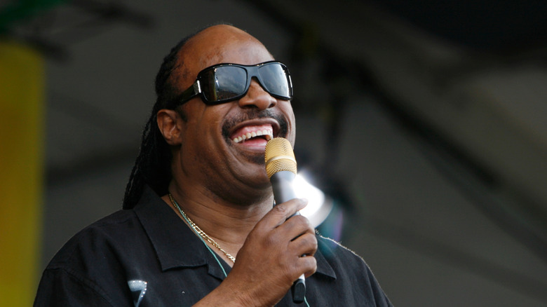 Stevie Wonder smiling with microphone