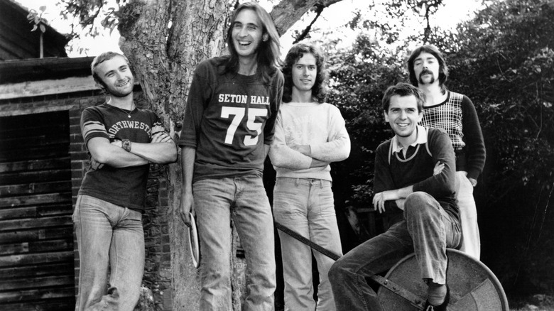 member of Genesis posing outside in 1972