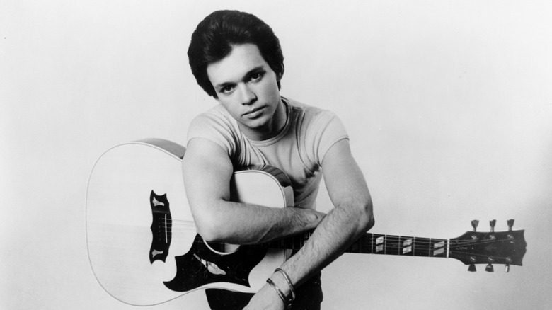 Johnny Cougar posing with guitar