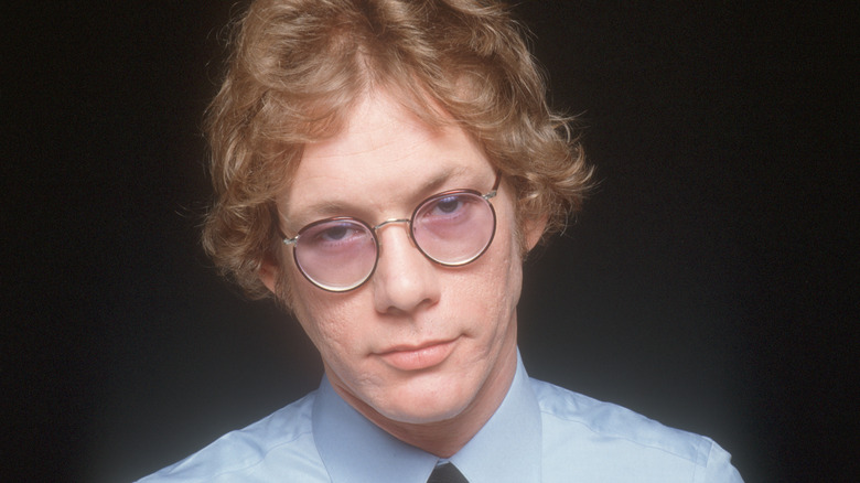 Warren Zevon wearing tie and round glasses in 1070