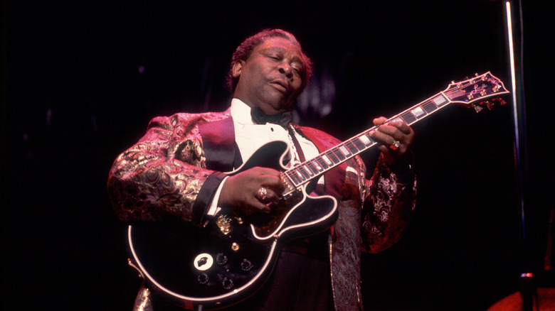B.B. King emotionally playing his guitar on stage