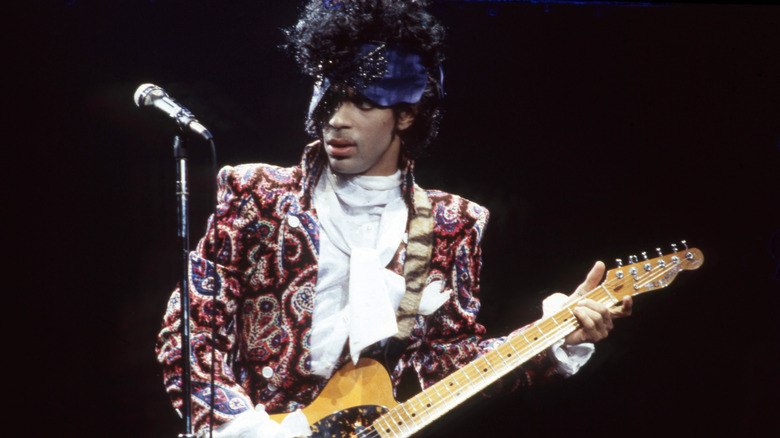 Prince playing guitar onstage