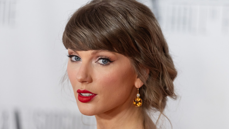 Taylor Swift on a red carpet looking to the side
