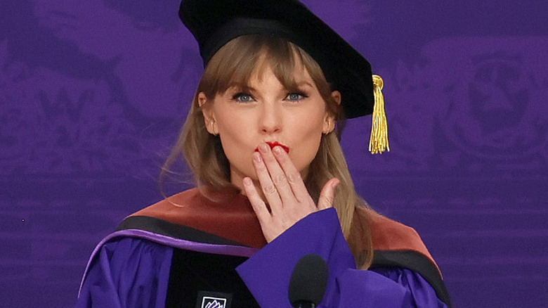 Taylor Swift sending a kiss during graduation