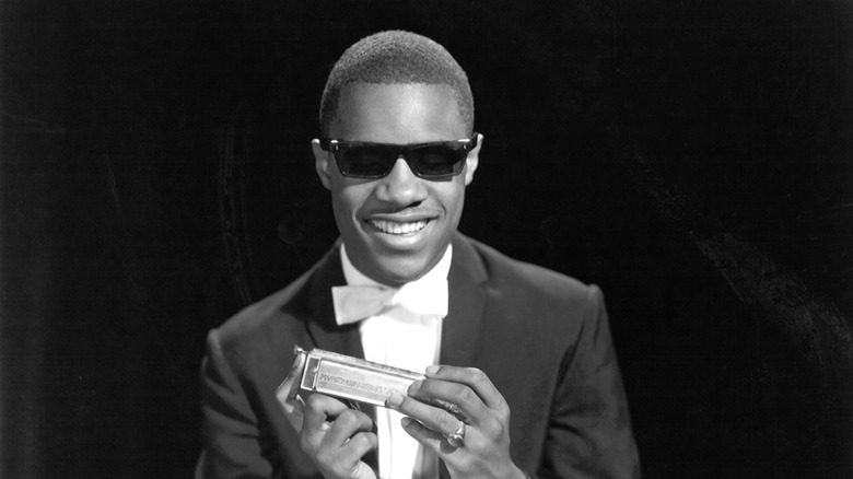 Stevie Wonder poses with harmonica in 1964