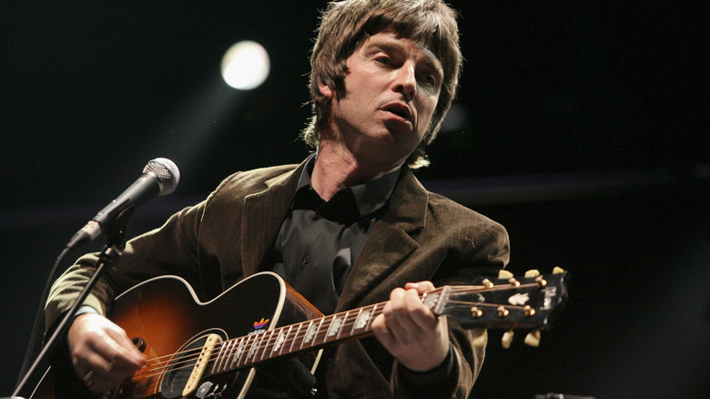 Noel Gallagher plays guitar