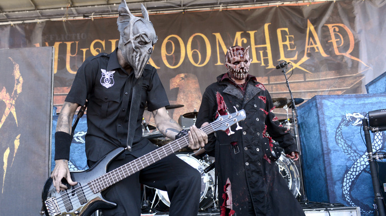 Mushroomhead in costume performing on stage