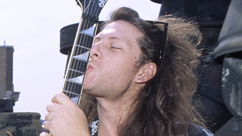 Criss Oliva kisses his guitar