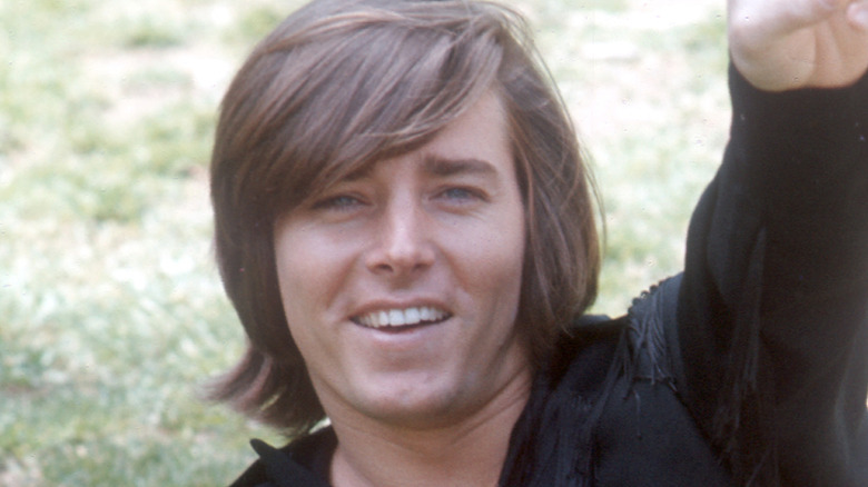 Bobby Sherman laying in grass and smiling