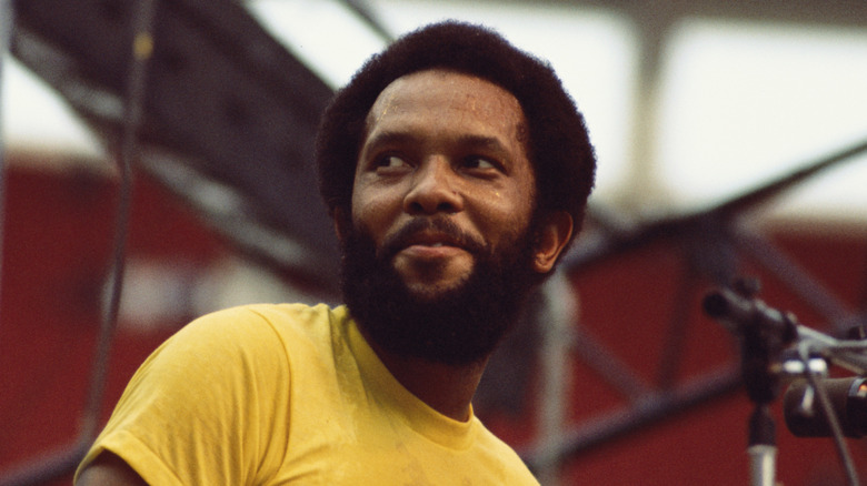 Roy Ayers on stage smiling and looking to side