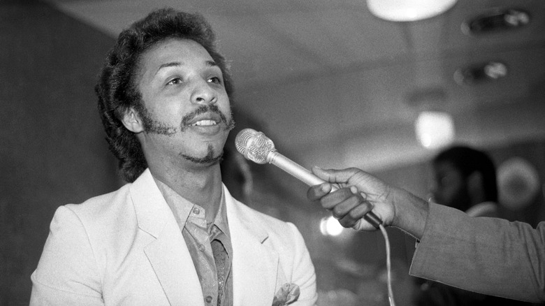 Chris Jasper speaking into microphone