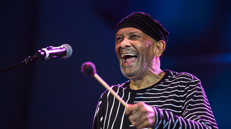Roy Ayers on stage with vibraphone mallet and microphone