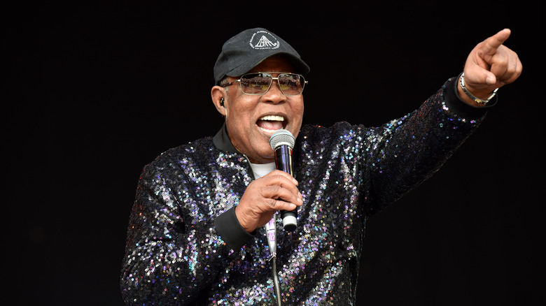 Sam Moore with microphone on stage