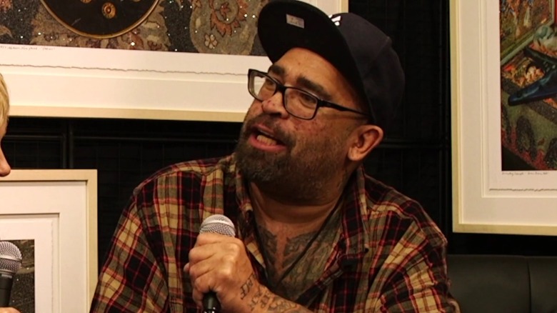 Jason Slater talking into microphone during interview