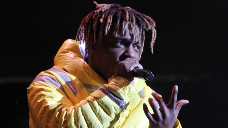Juice WRLD performing on stage in yellow parka