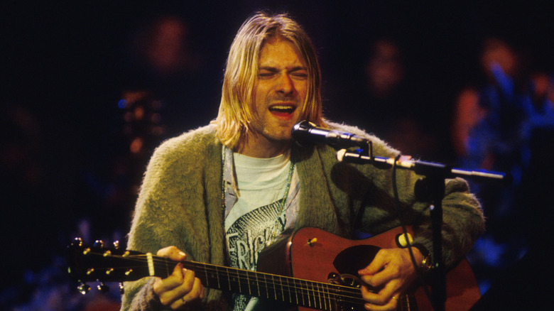Kurt Cobain singing and playing guitar on stage