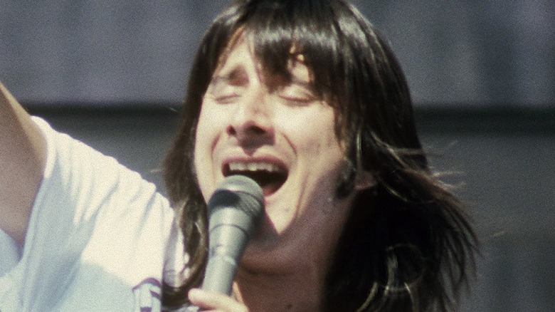 Steve Perry singing onstage eyes closed