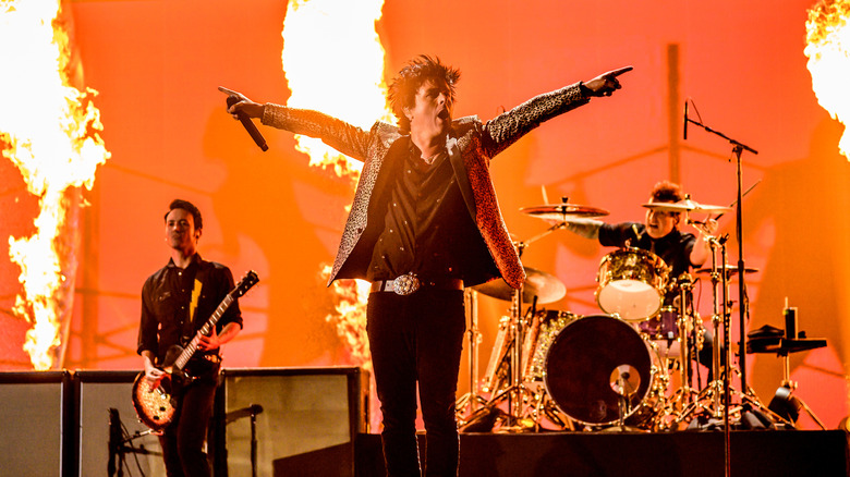 Microphone in stand on stage with drum kit in background