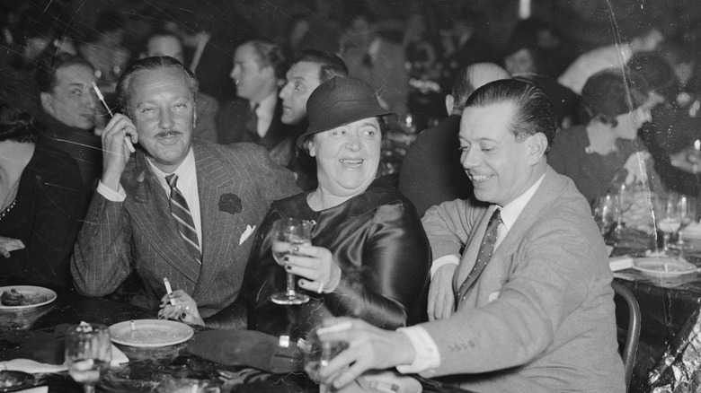 Cole Porter laughing and drinking with friends at a party