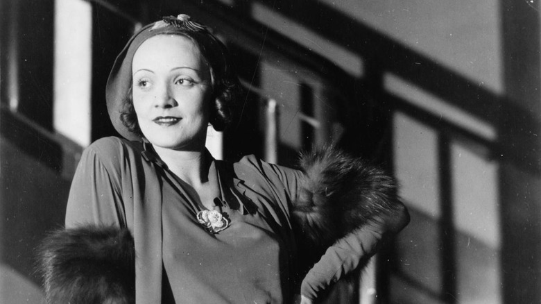 Marlene Deitrich posing in front of a staircase