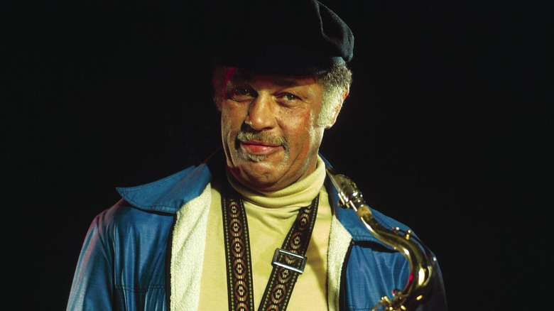Dexter Gordon blue jacket black hat saxophone smiling