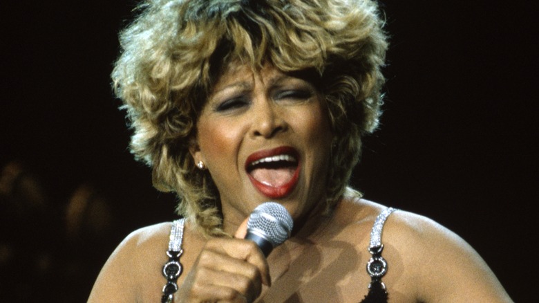 Tina Turner singing into microphone