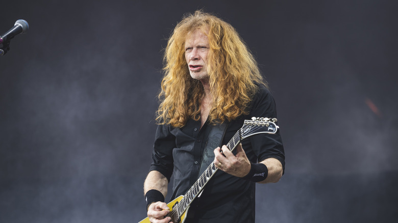 Dave Mustaine playing guitar on stage at a festival.