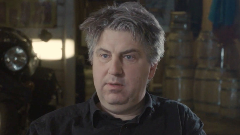 Helge Toft stares ahead in interview