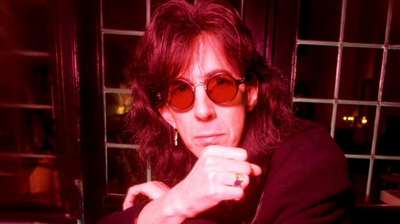 Ric Ocasek hand on chin in red light