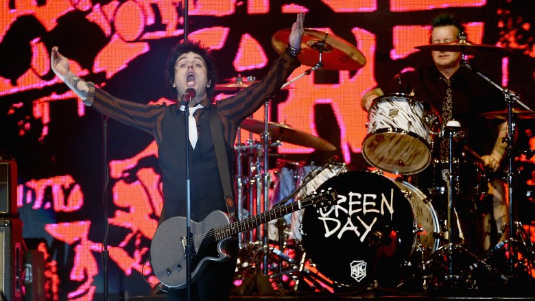 Billie Joe Armstrong singing hands raised