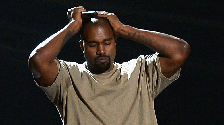 Kanye West hands on head