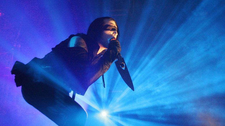 Marilyn Manson singing into knife-shaped microphone