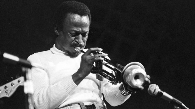 Miles Davis performing with trumpet