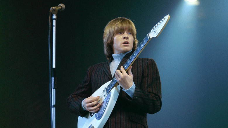 The Rolling Stones' Brian Jones playing guitar on stage in 1965