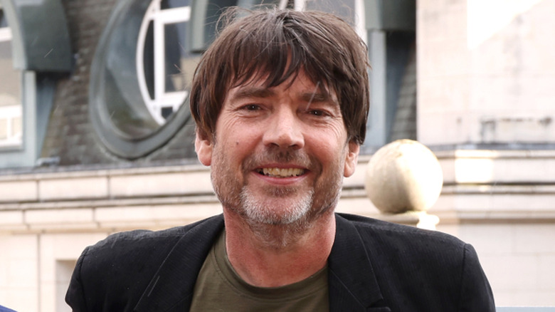 Alex James smiling in Blur publicity photo