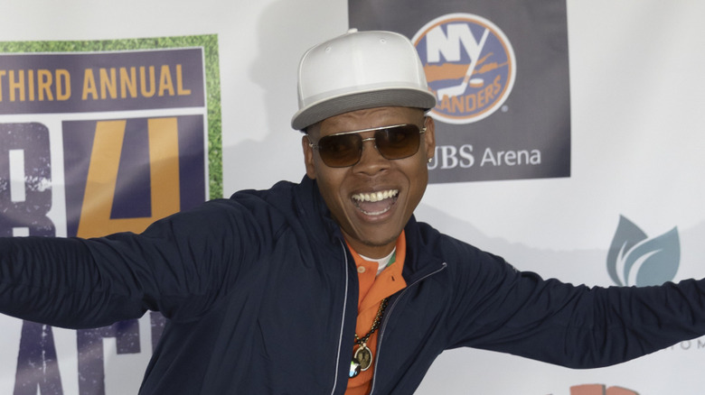 Ronnie DeVoe smiling big in white cap and sunglasses