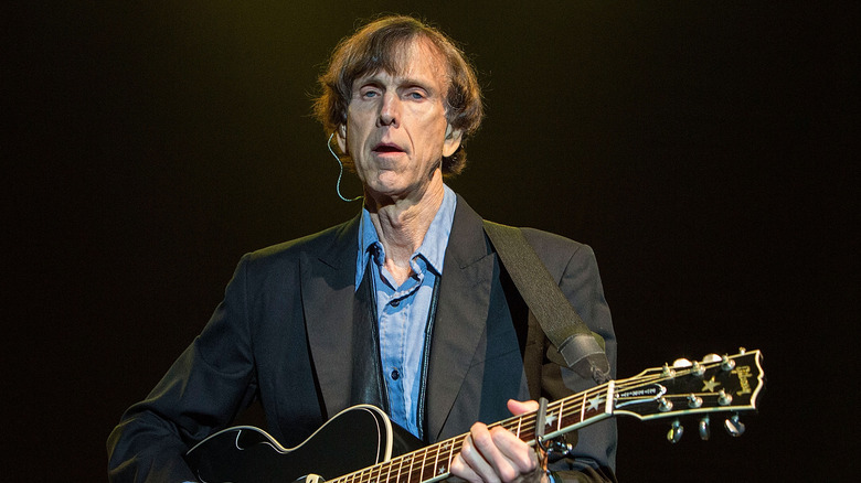 Tom Leadon playing guitar onstage