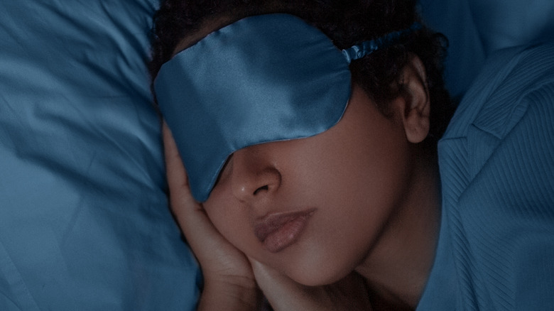 Sleeping woman wearing eye mask