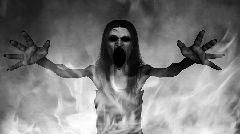A banshee raises her arms surrounded by white flames