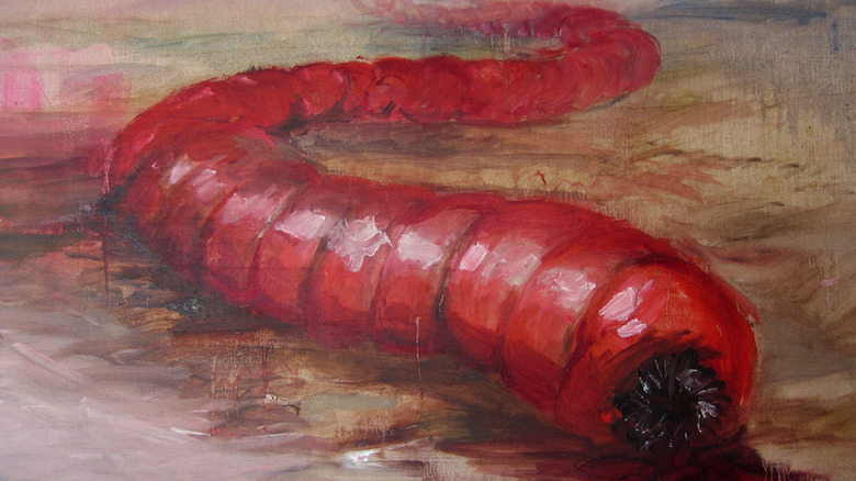 Painting of red worm with teeth slithering