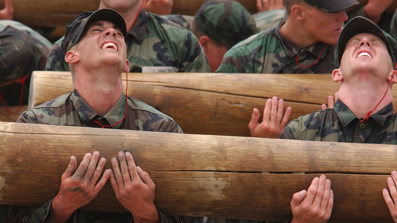 Soldiers lift logs