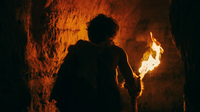 caveman holding a torch