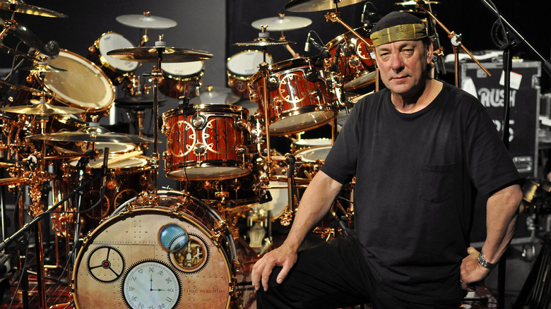 Neil Peart posing with drum kit