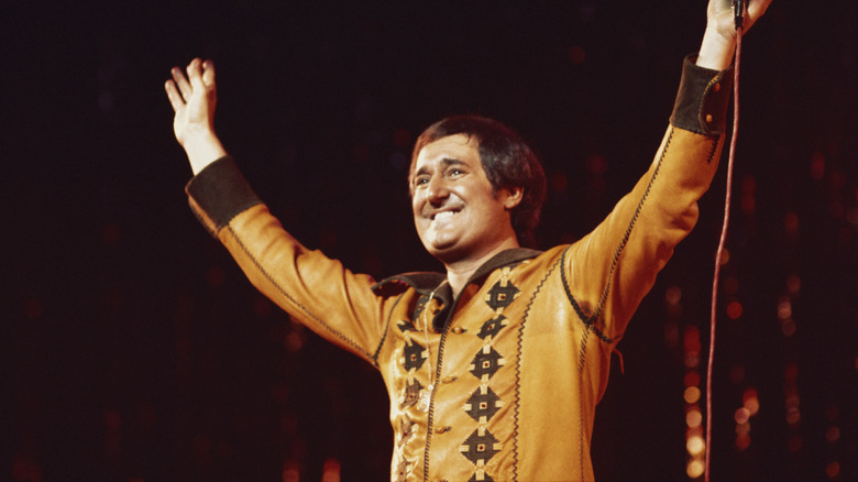 Neil Sedaka on stage waving to his audience, circa 1976.