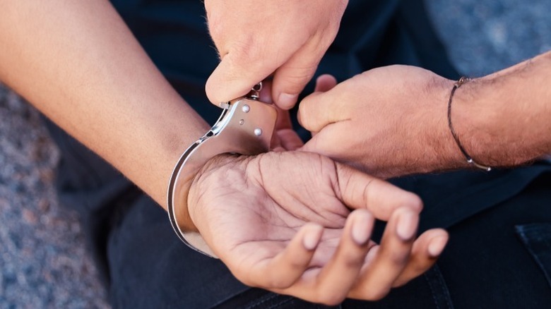 man being cuffed by police